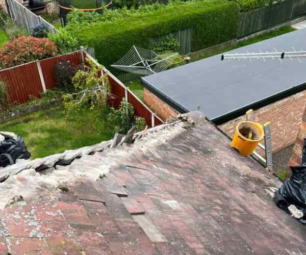 This is a photo of a roof hip that is having the hip (or bonnet) tiles replaced. Works carried out by WCT Roofing Long Buckby